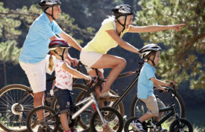 Active Grandparents riding bicycles with children