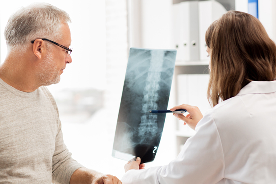 Doctor reviewing X-Ray with patient
