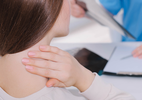 Doctor consulting patient with neck pain