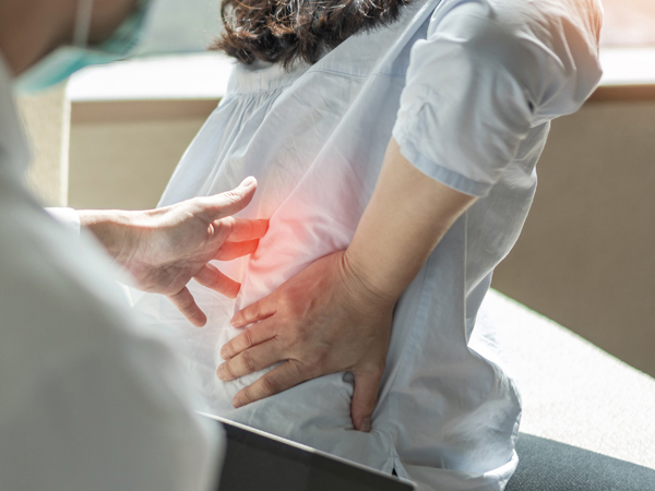 Doctor with patient with chronic back pain