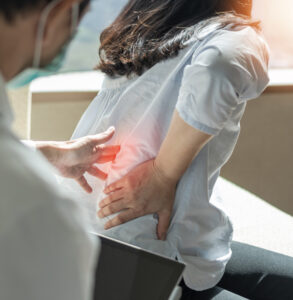 Doctor with patient with chronic back pain