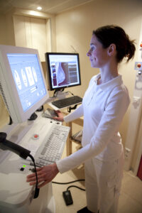 Mammography technician reviewing images