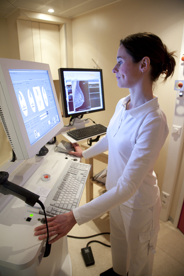 Mammography technician reviewing images